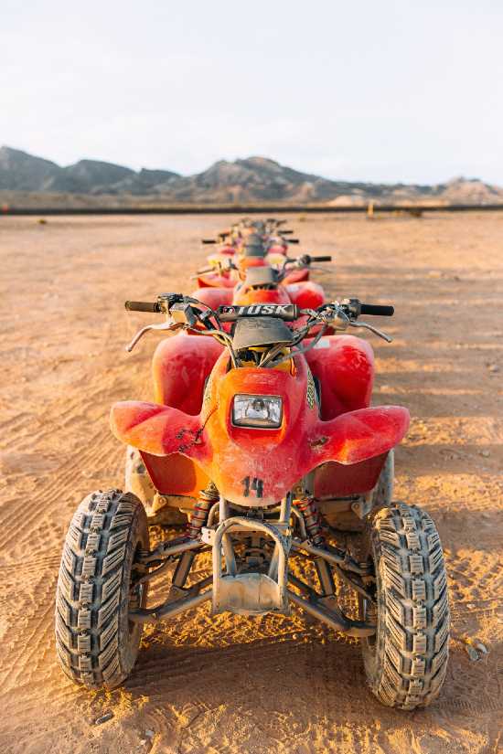 A huge group of ATV's lined up for about a mile