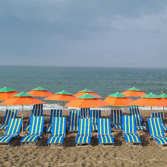 Picture of a beach full of empty lounge chairs