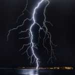 A picture of  a huge lightning strike on a lake